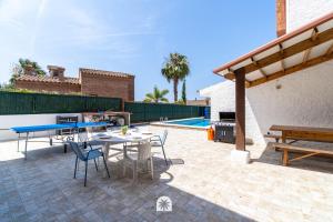 a patio with a table and chairs and a grill at Mediterranean Way - Apartamento privado en villa compartida con piscina in Tarragona +118 photos