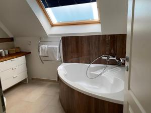 a bathroom with a sink and a window at Rheinblick Apartments in Cologne