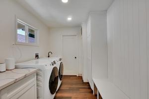 a white laundry room with a washing machine and a sink at A Cozy Home | Games | Dogs OK in Yuba City +23 photos