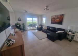 a living room with a couch and a table at Beautiful views lake golf house in Roldán