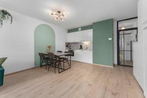 a kitchen and dining room with a table and chairs at Lilyta B201 in De Haan +3 photos