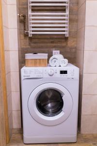 a washer and dryer in a small room at Przytulny Apartament w centrum Rabki in Rabka +10 photos