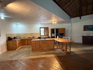 a kitchen with a wooden table in a room at The Secret Oasis Villa in Cap Malheureux