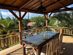 a wooden table on the deck of a house at The Secret Oasis Villa in Cap Malheureux