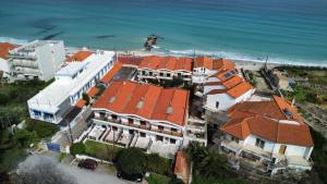 an aerial view of a house with orange roofs and the ocean at Salt & Pine in Kallithea Halkidikis