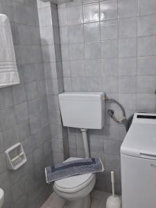 a small bathroom with a toilet and a sink at Salt & Pine in Kallithea Halkidikis
