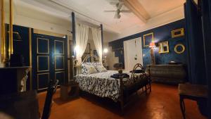 a bedroom with a bed and blue walls at Le N 9 in Argeliers