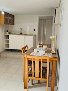 a kitchen with a wooden table with chairs and a dining room at Villa Margarita in Kyparissia +12 photos