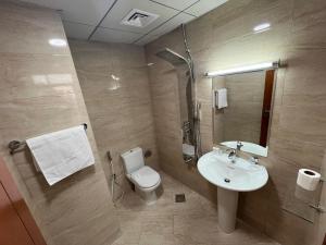 a bathroom with a toilet and a sink at Dubai Silicon Oasis Rental Apartments in Dubai +21 photos