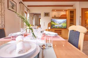 a dining room with a table and a television at Chalet Mallnock by Globalimmoservice in Bad Kleinkirchheim