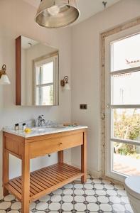 a bathroom with a sink and a mirror at Alasata Country House in Alacati