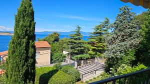 a view from the balcony of a house with trees at Apartments 4U in Omišalj