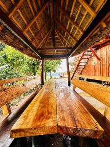 a wooden table in the middle of a building at Kasana Lake House in Isunga