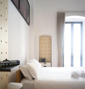 Łóżko lub łóżka w pokoju w obiekcie Imago Plus Hotel