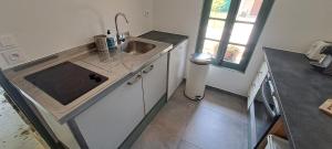 a kitchen with a sink and a counter top at Location Le Tilleul in Pélissanne
