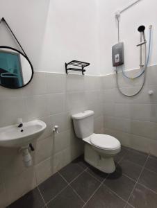 a bathroom with a toilet and a sink at Stella Homestay in Kampong Bemban
