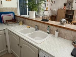 a kitchen counter with a sink in a kitchen at Les Cigales in Saint-Andiol +17 photos