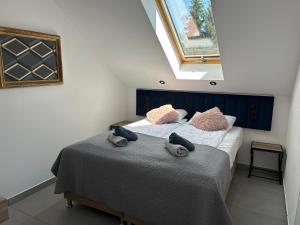 a bedroom with a bed with towels on it at Za Murem in Sandomierz