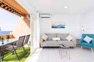 a living room with a couch and chairs and a table at Home2Book Duplex Rotia Caletillas Oceanview in Candelaria