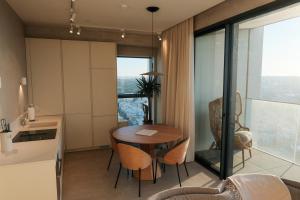 a kitchen and dining room with a table and chairs at Luxury 360 Sea View 27th Floor Apartment in Mercury Tower in St. Julianʼs