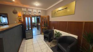 a waiting room with two chairs and a bar at Rožmberk Inn in Rožmberk nad Vltavou