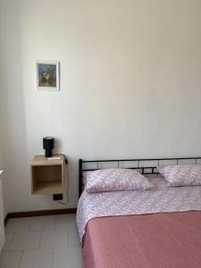 a bedroom with two beds and a small night stand at Marghera Central House in Marghera