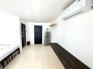 a kitchen with a refrigerator in the middle of a room at Patong Canal Villa 210 in Patong Beach