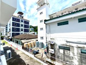 a group of people standing on the balcony of a building at Patong Canal Villa 210 in Patong Beach