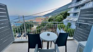 a balcony with a table and chairs and the ocean at Ponti Beach Hotel in Vasiliki