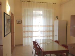 a dining room with a table and a refrigerator at A casa di Alessia in Manfredonia