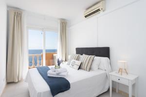 a bedroom with a bed with a view of the ocean at Home2Book Duplex Rotia Caletillas Oceanview in Candelaria +25 photos