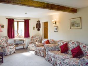 a living room with a couch and two chairs at Townfield Farm in Chinley