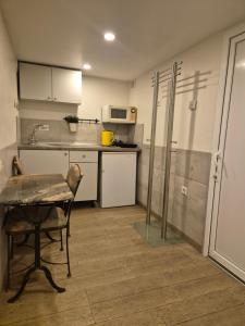 a small kitchen with a table and a microwave at Palanga S3 in Palanga +4 photos