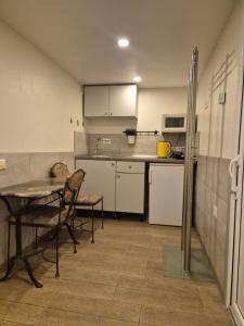 a kitchen with a table and a table and chairs at Palanga S3 in Palanga
