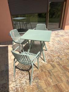 a white picnic table and chairs on a patio at Ana Apartment in Gradišča