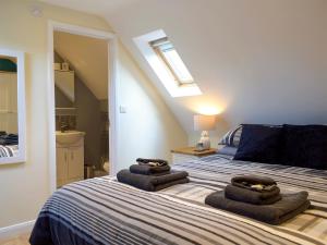 a bedroom with a bed with towels on it at Windhover in Glasbury +6 photos
