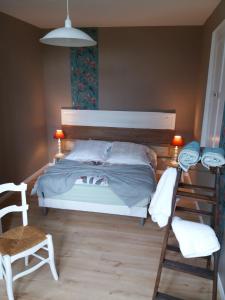 a bedroom with a bed and a desk and a chair at La Maison Bleue - La Belle Epoque in Rosières