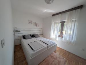 Posteľ alebo postele v izbe v ubytovaní Apartments Jurišević
