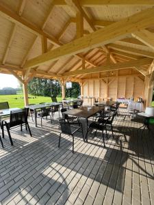 a wooden pavilion with tables and chairs on a patio at Noclegi u Eli Zator Energylandia in Zator