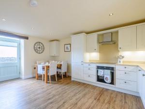 a kitchen with a table and a dining room at Stable View in Peak Forest