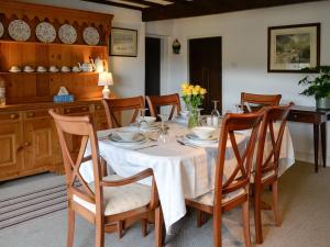 a dining room with a table with a white table cloth at East House Farm in Beckermonds