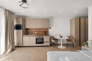 a kitchen and living room with a bed and a table at Apartments Hana&Petra in Rovinj +8 photos