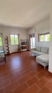 a living room with two couches and a tile floor at Villa Saracena in Francavilla al Mare