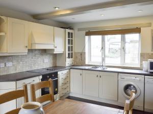 a kitchen with white cabinets and a dishwasher at York House in Richmond