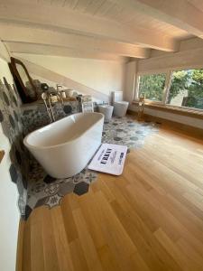 a bathroom with a large white tub and two toilets at Villa Saracena in Francavilla al Mare +47 photos