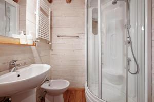 a white bathroom with a sink and a shower at Le Fratte in Pertica Alta