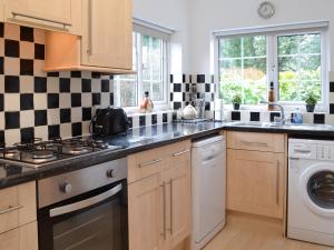 a kitchen with a sink and a stove top oven at Oakwood in Bridlington