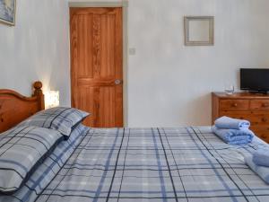 a bedroom with a bed with blue towels on it at Oakwood in Bridlington