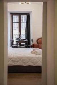 a bedroom with a bed and a table and a window at the Heart of Turin Center in Turin
