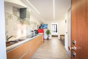 a kitchen with two sinks and a long hallway at the Heart of Turin Center in Turin +11 photos